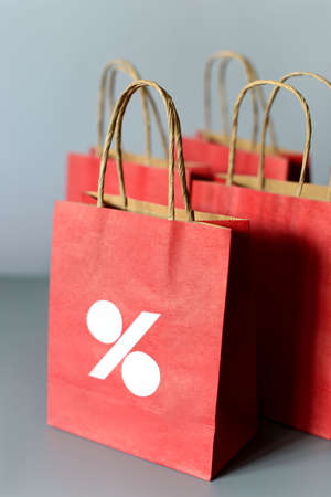 Red shopping bags from recycle paper isolated on white background. Black friday or Christmas sales.の写真素材