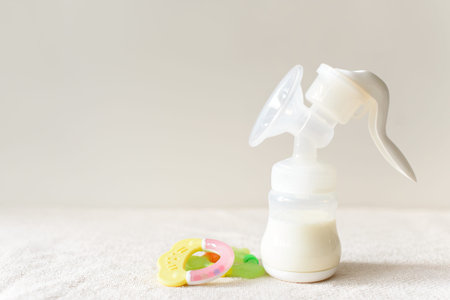 Breast pump and bottle with milk for baby