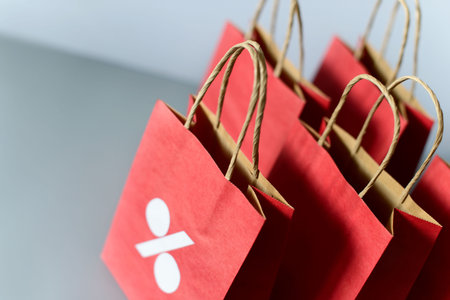 Red shopping bag from recycle paper isolated on white background. Black friday or Christmas sales.