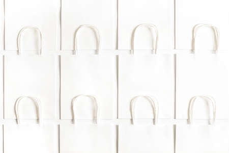 Background of white bags isolated on white. Sales and shopping.の写真素材