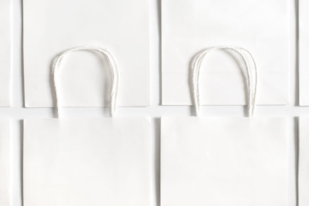 Background of white bags isolated on white. Sales and shopping.の写真素材