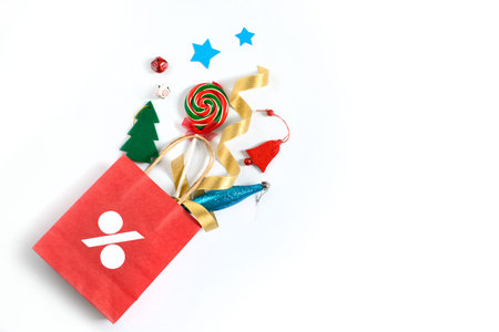 Christmas gifts falling from the red shopping bag, holiday presents isolated on white background, free copy spaceの写真素材
