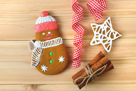 Christmas cookies with festive decoration on wooden background. Free copy space.