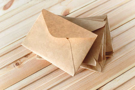 Envelopes from craft paper on the wooden background.の写真素材