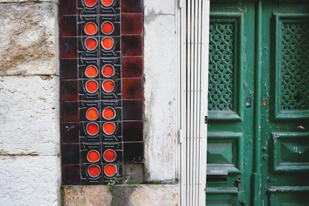 Traditional wooden door and ceramic tiles mosaic wall in Lisbon, Portugal