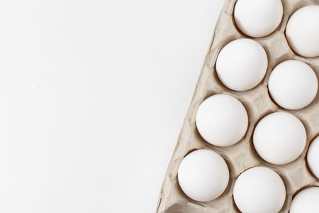 White eggs in craft package on a white background. Easter photo concept. Copy space. View from above.の写真素材