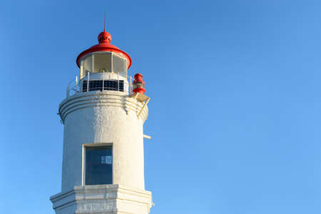 Lighthouse on the seacoast at sunset light. Nature background. Free copy space.の写真素材