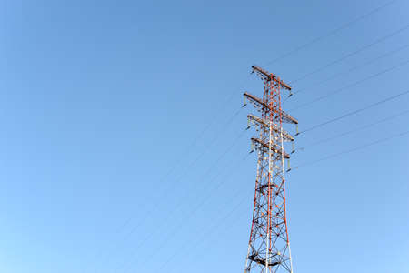 Pylon and transmission power line in front of sky. Free copy space.の写真素材