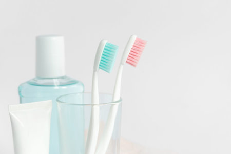 Toothbrushes, toothpaste, rinse and towel on white background. Dental and healthcare concept. Free copy space.の写真素材