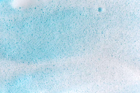 Soap foam bubbles on blue background macro close up.の写真素材