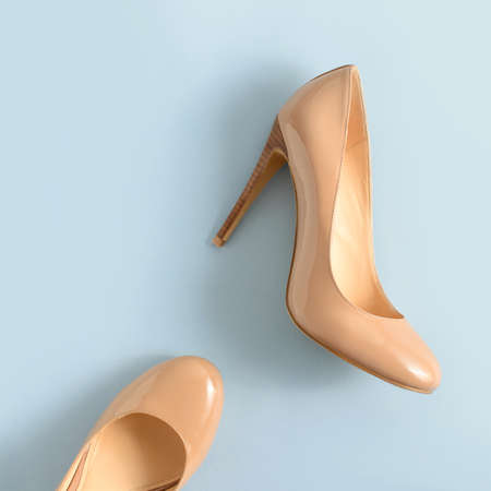 Beige women high heel shoes on pink background.の写真素材