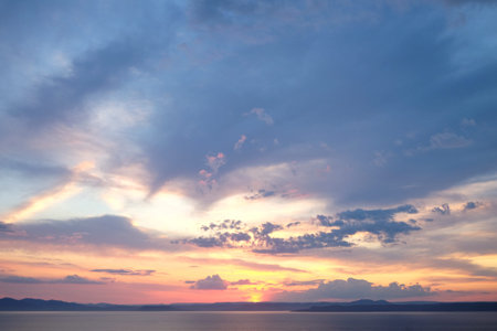 Beautiful sunrise in sea with dramatic clouds background