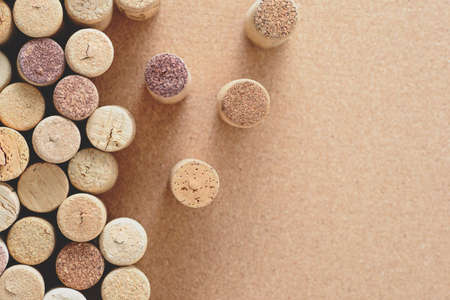 Pile of assorted used wine corks on brown natural craft cork background. Close up top view. Free copy space.の写真素材