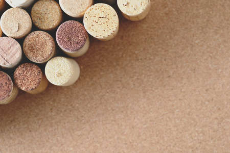 Pile of assorted used wine corks on brown natural craft cork background. Close up top view. Free copy space.の写真素材
