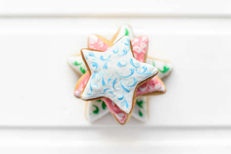 Christmas cookies with festive decoration and on white wooden background. New Year and Christmas concept.の写真素材