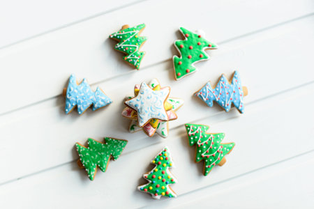 Christmas cookies with festive decoration and on white wooden background. New Year and Christmas concept.の写真素材