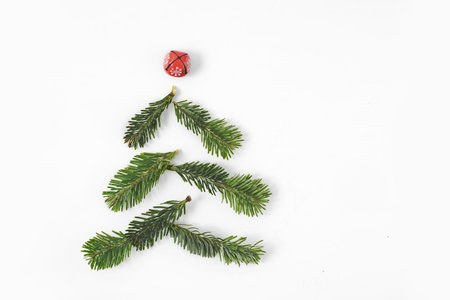 Christmas tree shape made of fir-tree branches isolated on white background. Free copy space.の写真素材