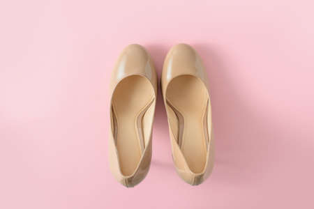 Beige women high heel shoes on pink background. Fashion blog look. Top view, flat lay.の写真素材