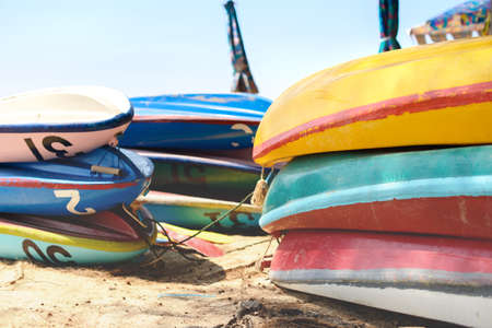 Kayaks on sand beach. Colorful boats in front of sea coast. Vacation and travel sport activity.の写真素材