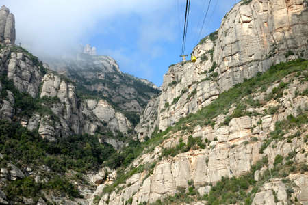 Yellow cable car to the Church of Santa Maria de Montserrat in the mountains of Montserrat near Barcelona, Spain, Catalonia.の写真素材