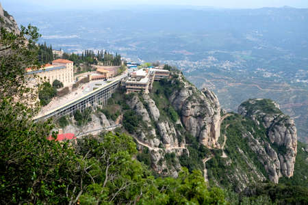 Santa Maria de Montserrat Abbey in Monistrol de Montserrat Monastery view from above located nearby from Barcelona in Catalonia, Spainの写真素材