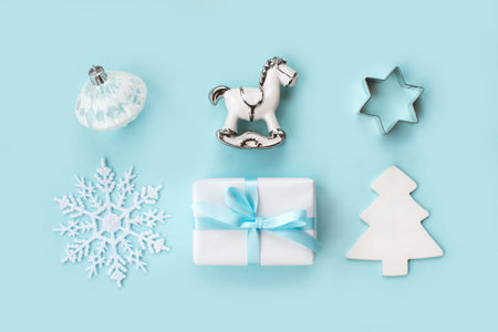 Set of various white and silver Christmas details: gifts and toys on light blue background. Top view, flat lay.の写真素材