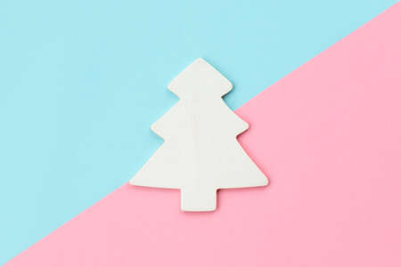 White Christmas tree on pink and light blue background. New Year, Christmas and winter concept. Flat lay, top view.の写真素材