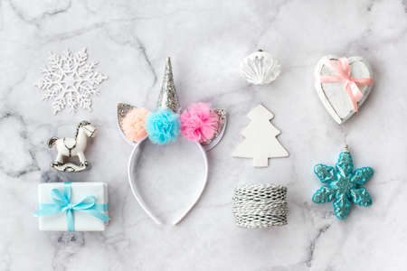 Set of various white, pink and blue Christmas decorations: gifts and toys on marble background. Top view, flat lay.の写真素材