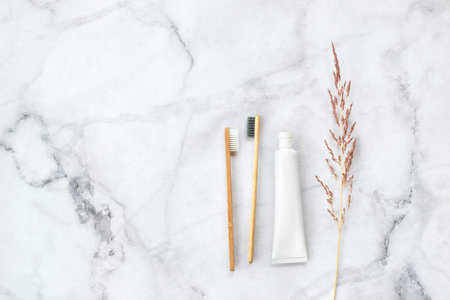 Set of eco-friendly toothbrushes and toothpaste on marble background. Dental and healthcare concept....