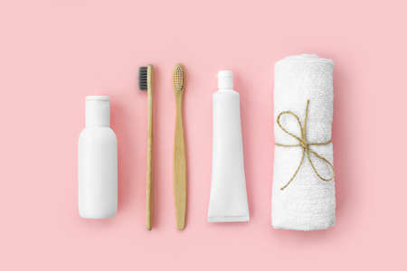 Set of eco-friendly toothbrushes, toothpaste and other tools on pink background. Dental and healthcare concept. Top view, flat lay.の写真素材