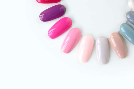 Nail polish samples in different bright colors. Colorful nail lacquer manicure swatches. Top view of nail art wheel palette.の写真素材