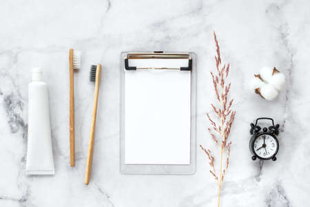 Set of eco-friendly toothbrushes, toothpaste and note free copy space and marble background. Dental and healthcare concept. Top view, flat lay.の写真素材