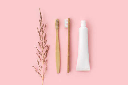 Set of eco-friendly toothbrushes, toothpaste and other tools on pink background. Dental and healthcare concept. Top view, flat lay.の写真素材