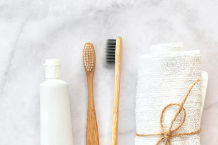 Set of eco-friendly toothbrushes, toothpaste and cotton towel on marble background. Dental and healthcare concept. Top view, flat lay.の写真素材