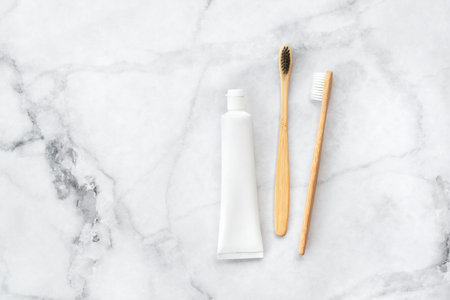 Set of eco-friendly toothbrushes and toothpaste on marble background. Dental and healthcare concept. Top view, flat lay. Free copy space.の写真素材