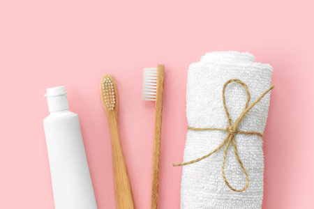 Set of eco-friendly toothbrushes, toothpaste and other tools on pink background. Dental and healthcare concept. Top view, flat lay.の写真素材