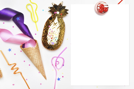 Template menu. White Frame. Ice cream Cone, tubes for cocktails, confetti. Party invitation mock-up. Flat lay, Cake with strawberries, colored tape. White background with party accessories.golden itemの写真素材