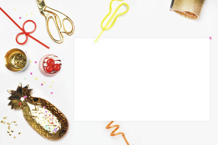 Party invitation mock-up. Flat lay, Cake with strawberries, colored tape. White background with party accessories.golden item. White blank on the tableの写真素材