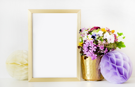Gold frame mock-up, and white wall with gold vase, and flowers. Place workの写真素材
