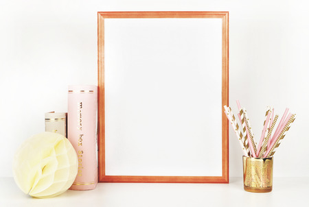 wooden picture frame with decorations. Mock up for your photo or text Place your work, print art,shabby style, white background, paper ball, toy, pastel color bookの写真素材