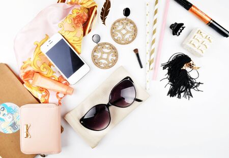 Woman desk on the white table, makeup accessories and jewerly with perfume. Female white mock-up background. Flat layの写真素材