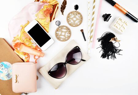Woman desk on the white table, makeup accessories and jewerly with perfume. Female white mock-up background. Flat layの写真素材