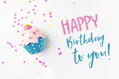 White background with party accessories. Invitation mockup. Confetti and muffins. cakeの写真素材