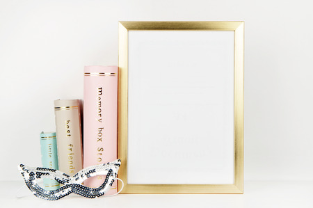 gold picture frame with decorations. Mock up for your photo or text Place your work, print art,shabby style, white background,, pastel color book, paris, lipstick, mint and gold accessoriesの写真素材