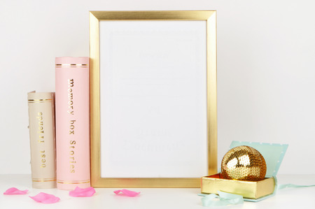 Gold frame mock-up, and white wall with gold book, and woman things. Place workの写真素材