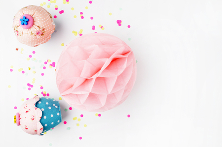 White background with party accessories. Invitation mockup. Confetti and muffins. cakeの写真素材