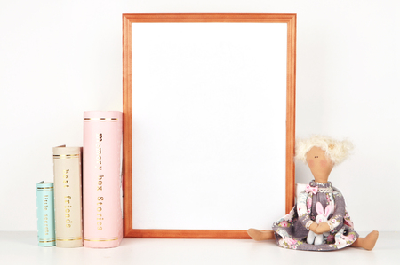 wooden picture frame with decorations. Mock up for your photo or text Place your work, print art,shabby style, white background, paper ball, toy, pastel color bookの写真素材