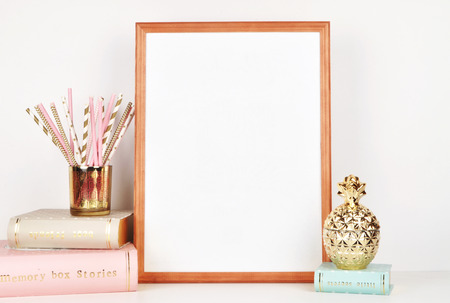 wooden picture frame with decorations. Mock up for your photo or text Place your work, print art,shabby style, white background, paper ball, toy, pastel color bookの写真素材
