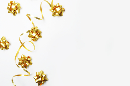 Top view. White background with gold decoration. Gold ribbon. Flat lay. Party mockupの写真素材