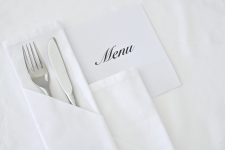 White linen table place setting with menuの写真素材